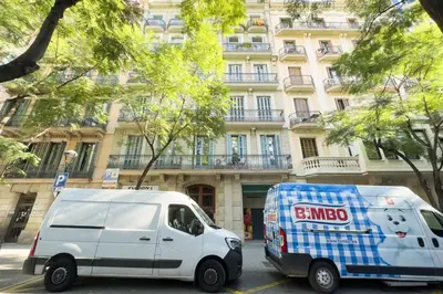 a white van parked in front of a building at ApartEasy - Passeig de Gracia in Barcelona