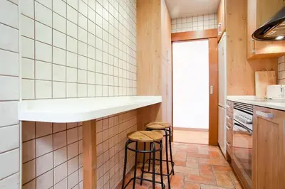 a kitchen with a counter and stools in it at ApartEasy - Atic Sagrada Familia in Barcelona