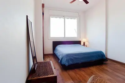 a bedroom with a bed and a window at ApartEasy - Atic Sagrada Familia in Barcelona
