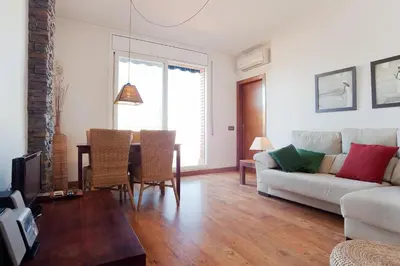 a living room with a couch and a table at ApartEasy - Atic Sagrada Familia in Barcelona