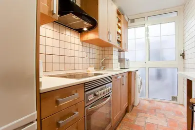 a kitchen with a sink and a stove at ApartEasy - Atic Sagrada Familia in Barcelona