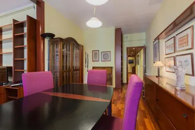 a dining room with a black table and purple chairs at ApartEasy - Port Barcelona in Barcelona