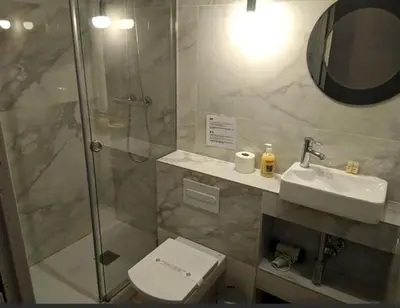 a bathroom with a shower and a toilet and a sink at ApartEasy - Family Sant Antoni apt. in Barcelona