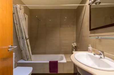 a bathroom with a bath tub and a sink at ApartEasy - Family Apartment Sant Antoni in Barcelona