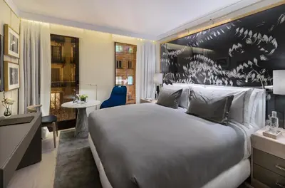 a hotel room with a large bed and a desk at The One Barcelona GL in Barcelona