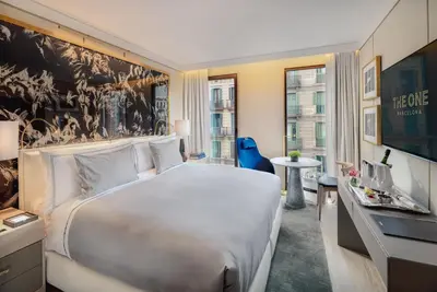 a hotel room with a large bed and a desk at The One Barcelona GL in Barcelona