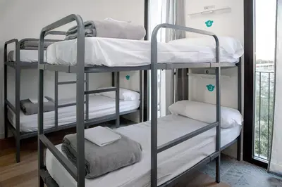 two bunk beds in a room with a window at Meeting Point Hostels in Barcelona