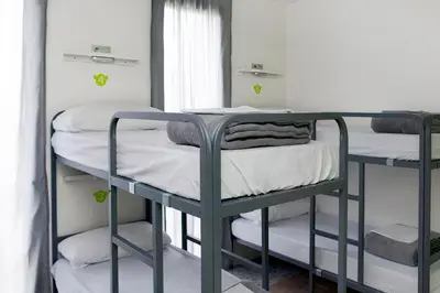 two bunk beds in a room with a window at Meeting Point Hostels in Barcelona