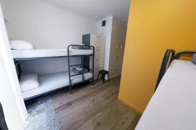 a room with two bunk beds and a wooden floor at Meeting Point Hostels in Barcelona