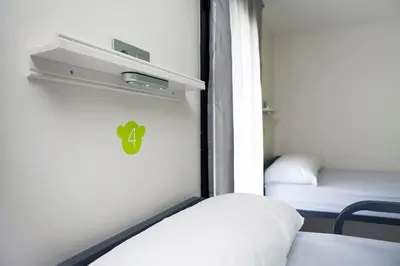 a small room with a bed and a small room with a bed sqor at Meeting Point Hostels in Barcelona