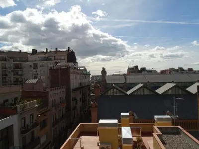 a view of the city from the roof of a building at Feel at Sants Apartments in Barcelona