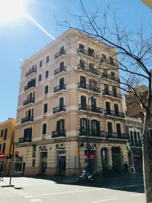 a large building on the corner of a street at Feel at Sants Apartments in Barcelona