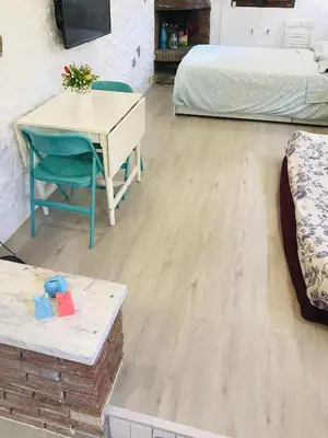 a room with a desk and a table and a bed at Heart of Gracia in Barcelona