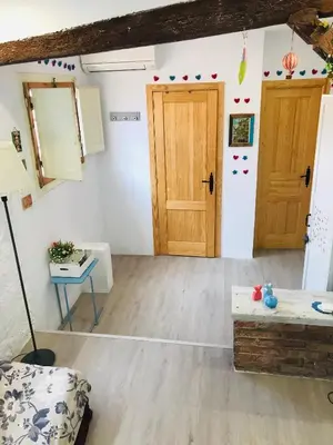 a living room with two doors and a table at Heart of Gracia in Barcelona