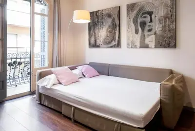 a bed in a room with two pillows on it at Tendency Plaza España in Barcelona