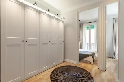 a bedroom with white cabinets and a bed and a rug at Sagrada Familia V in Barcelona