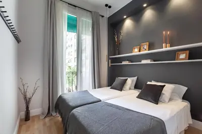 a bedroom with two beds and a window at Sagrada Familia V in Barcelona