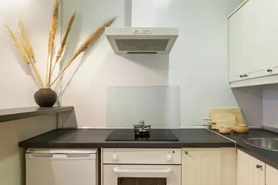 a kitchen with a black counter top and a sink at Sagrada Familia V in Barcelona