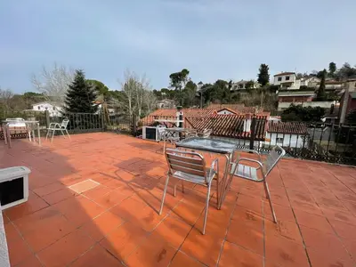 a patio with a table and chairs on a brick patio at Hostal del Carmen in Terrassa