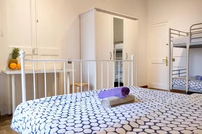 a bedroom with a bed with a pillow on it at Grand Central Apartment in Barcelona