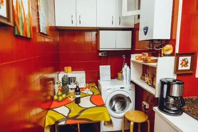 a small kitchen with a washing machine in it at Grand Central Apartment in Barcelona