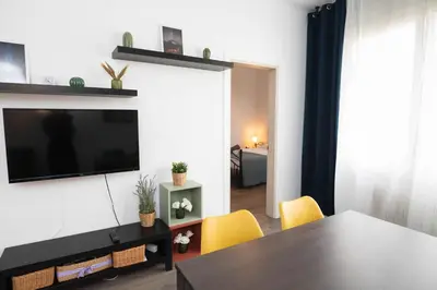 a living room with a flat screen tv on a wall at Apartment Carrer de Joan in Barcelona