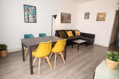 a dining room with a table and chairs and a couch at Apartment Carrer de Joan in Barcelona