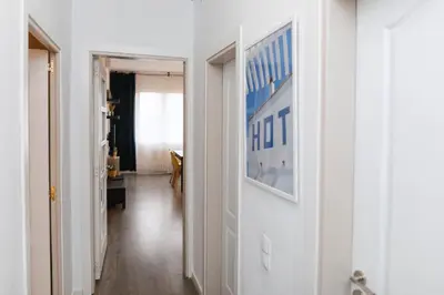 a hallway with white walls and a picture on the wall at Apartment Carrer de Joan in Barcelona