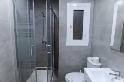 a bathroom with a shower and a toilet and a sink at Apartment Carrer de Joan in Barcelona
