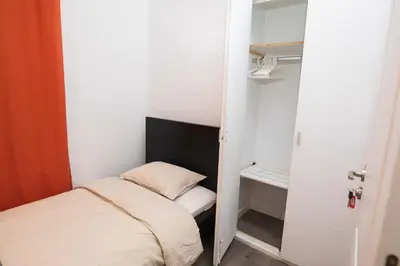 a small room with a bed and a closet at Apartment Carrer de Joan in Barcelona