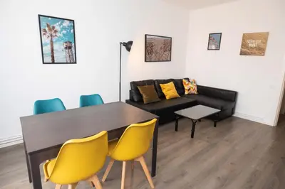 a living room with a table and a couch at Apartment Carrer de Joan in Barcelona