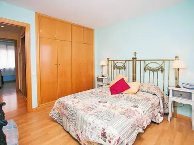 a bedroom with a bed and a wooden cabinet at Apartment Mariola by Interhome in Sant Andreu de Llavaneres