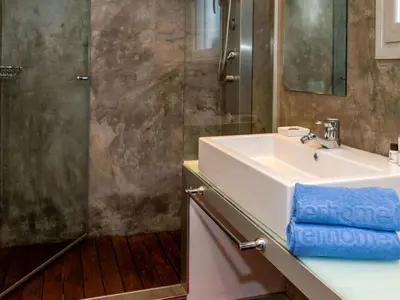 a bathroom with a white sink and a shower at Holiday Home Ginesteres by Interhome in Argentona