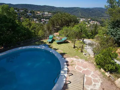 a swimming pool with a view of a mountain at Holiday Home Ginesteres by Interhome in Argentona