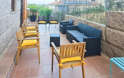 a row of chairs and tables on a patio at Gorgeous Home In Alella in Alella