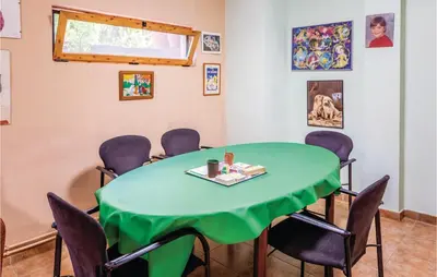 a meeting room with a green table and chairs at Gorgeous Home In Alella in Alella