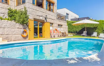 a swimming pool in front of a house at Gorgeous Home In Alella in Alella