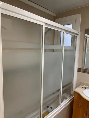 a glass shower in a bathroom with a sink at Channing Apartment in Barcelona