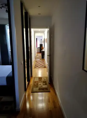 a hallway leading to a bedroom with a bed and a room with a hallwayngth at Channing Apartment in Barcelona