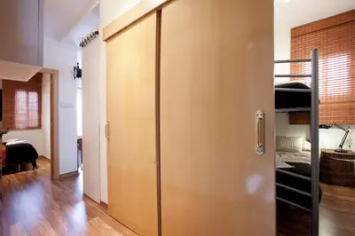 a room with a wooden door and a bedroom at Penthouse in Sagrada Familia in Barcelona