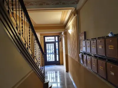 a hallway with a stairway with a bunch of lockers at Penthouse in Sagrada Familia in Barcelona