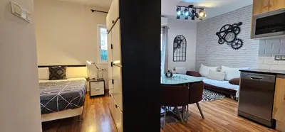 a bedroom and a living room with a bed and a kitchen at Penthouse in Sagrada Familia in Barcelona