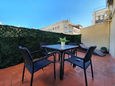 a patio with a table and chairs on a balcony at Penthouse in Sagrada Familia in Barcelona