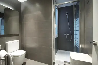 a bathroom with a toilet and a shower at Dalí Residence in Barcelona