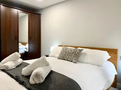 a bedroom with a white bed with towels on it at Dalí Residence in Barcelona