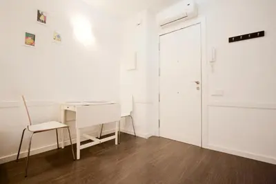 a white room with a desk and a chair at Dalí Residence in Barcelona
