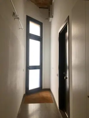 an empty room with a door and a window at Dalí Residence in Barcelona