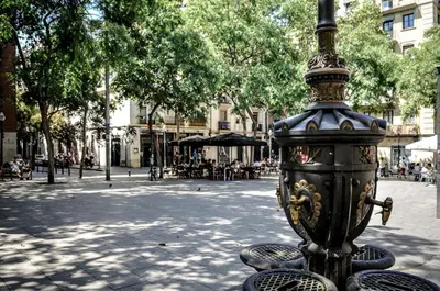 a black fire hydrant on a city street at Lovely loft near Barcelona center in Barcelona