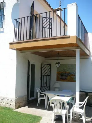 a patio with a table and chairs under a balcony at Sunway Torre La Veleta in Sitges