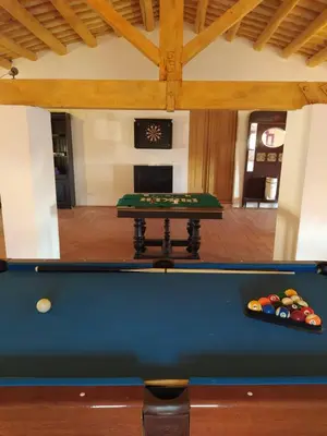 a pool table in the middle of a room at Can plana de baix in San Pol de Mar